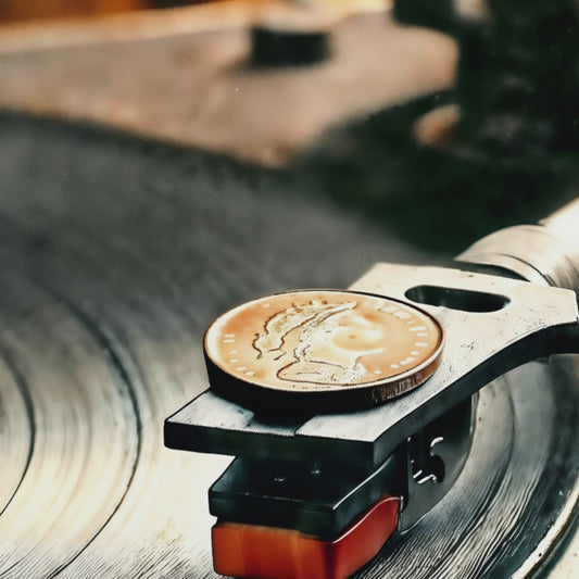 Video showcasing a close-up view of a turntable with a coin-weighted stylus playing an orange label vinyl, perfect for a modern music studio décor.