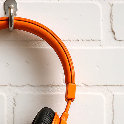 Orange Headphones Clean - Arts To GloryOrange Headphones CleanDigital Wall ArtArts To GloryClose - up of modern digital artwork showcasing vibrant orange headphones set against minimalist white brick, crafted by Arts To Glory.