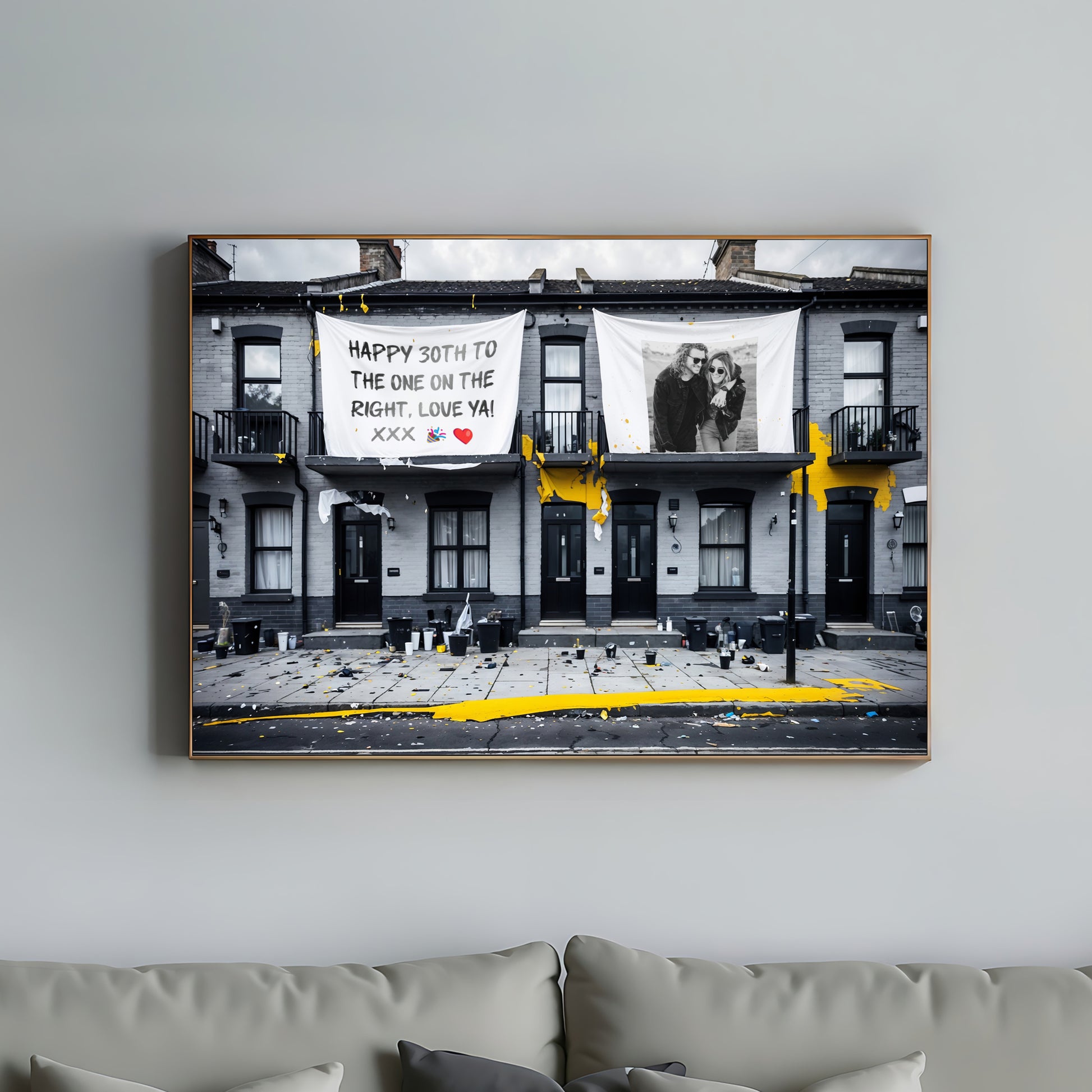 Personalised Urban Art of a house front scene depicting the morning after a house party, with customizable text and images, featuring black and yellow accents, displayed above a modern sofa in a living room setting.