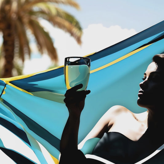 woman drinking cocktail on a hammock